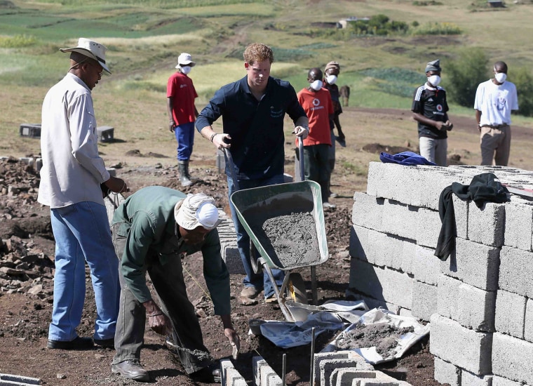 Image: Britain's Prince Harry helps lay the foundations for the new Sentebale Mateanong Herd Boy School, in Mokhotlong, Lesotho